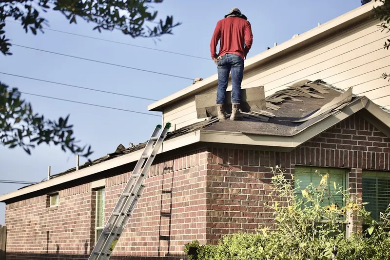 Professional roofer working on a residential roof in Grosse Pointe Park